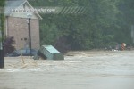 Flood carries shed across road