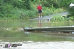 Man surveys flooded road