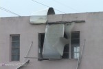 Awnings rip from a building