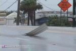 Siding tumbles down a street
