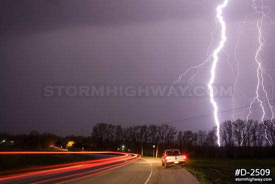 Intense lightning over a rural Missouri road at night
