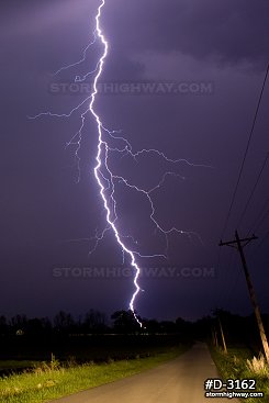 Lightning over rural Indiana countryside and road at night