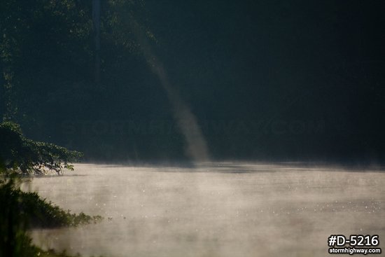 Steam devil vortex on a foggy lake surface
