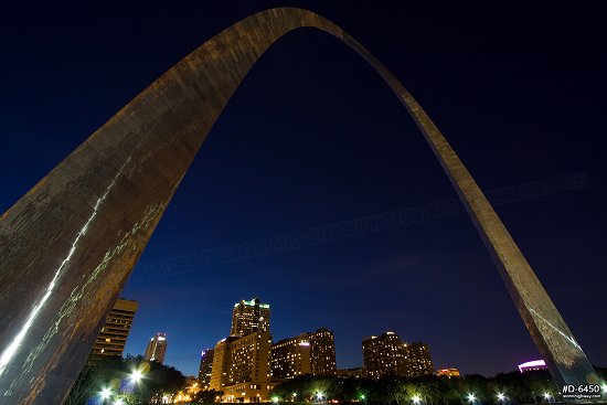 Gateway Arch close-up with St. Louis skyline at twilight