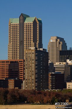 Vertical view of downtown buildings in early morning sunlight with blue sky