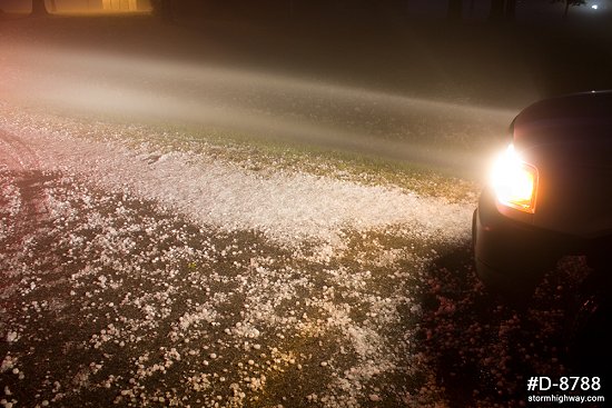 Hail covering road at night
