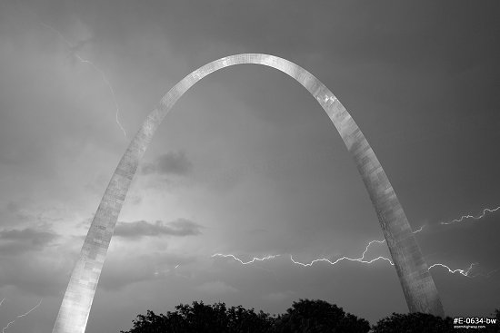 Lightning behind the Gateway Arch in St. Louis, MO during a nighttime storm, black and white