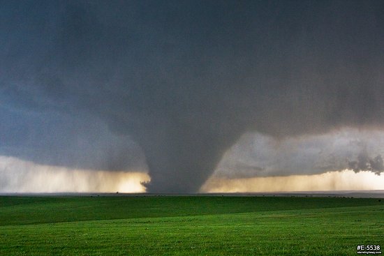 A large, dark tornado looms over green Kansas prairie near the town of Bennington
