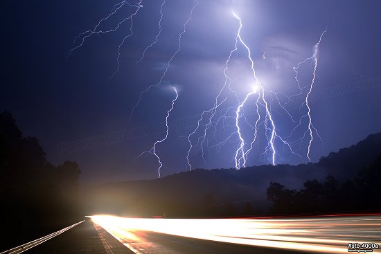 Lightning at night over traffic on an Appalachian highway in West Virginia