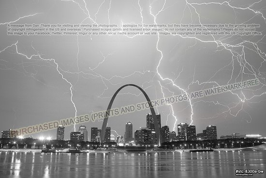 Lightning fills the sky over the Gateway Arch and downtown St. Louis, black and white