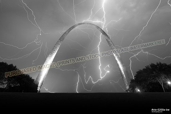 Lightning fills the sky over the Gateway Arch, black and white