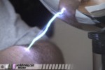Spark jumps to demonstrator's arm